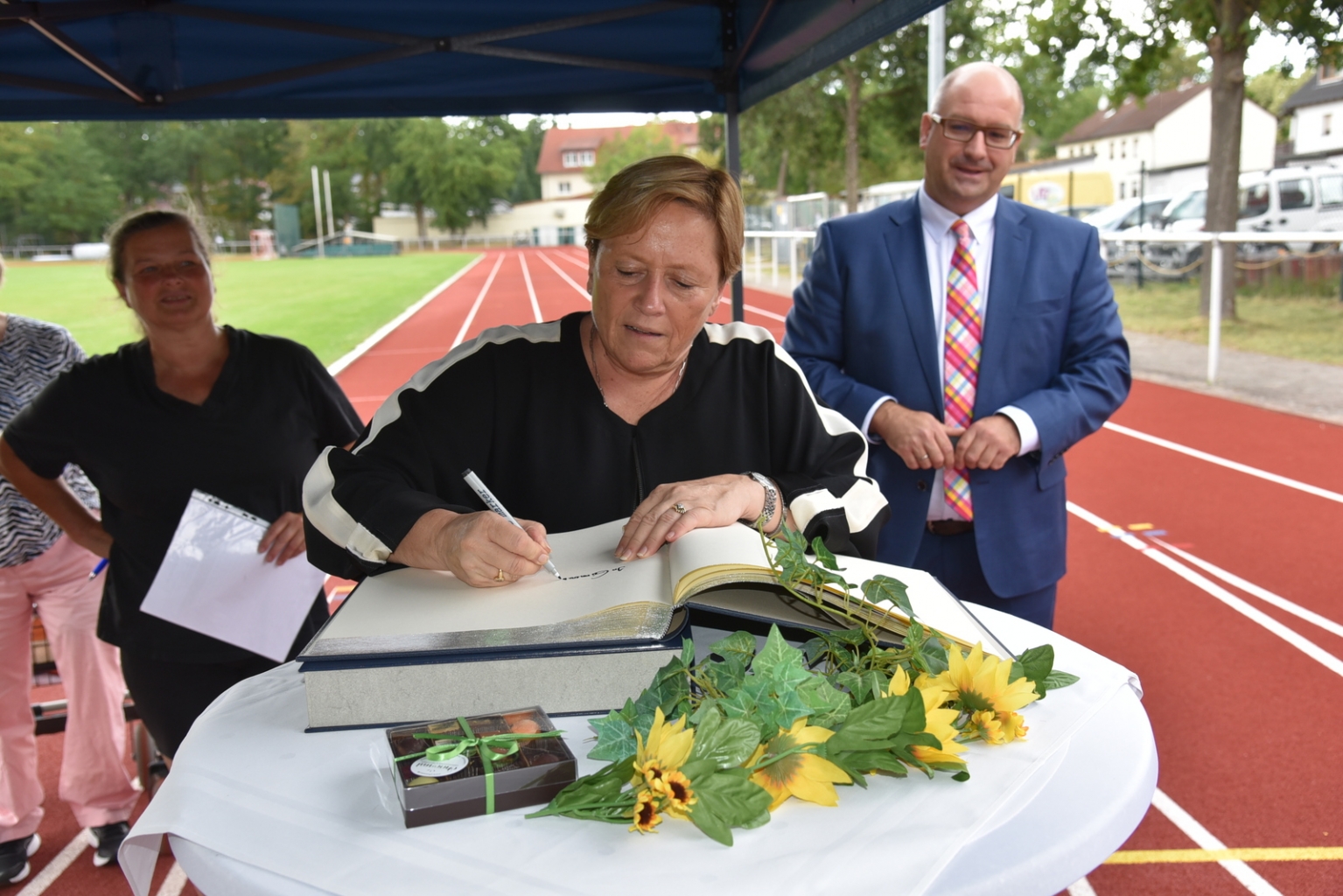 Ministerin Dr. Susanne Eisenmann trägt sich ins Goldene Buch der Gemeinde ein.